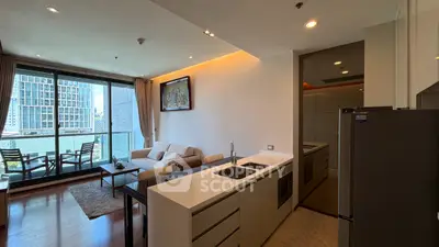 Modern open-layout living room with kitchen and balcony view in urban apartment