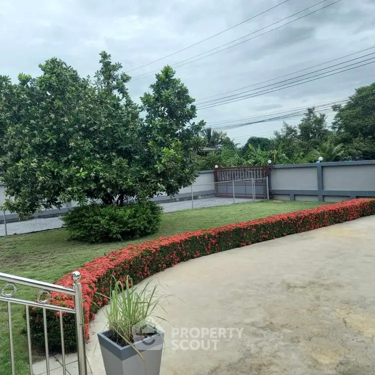 Charming garden view with lush greenery and paved patio area.