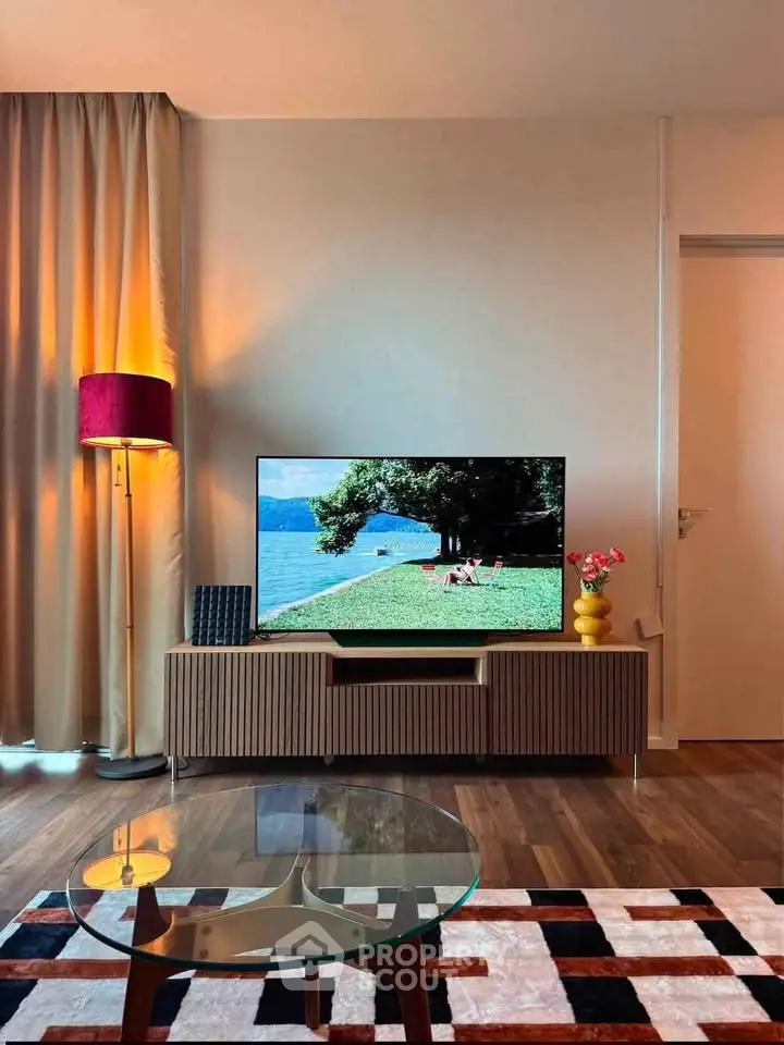 Stylish living room with modern decor, featuring a flat-screen TV and elegant furniture.