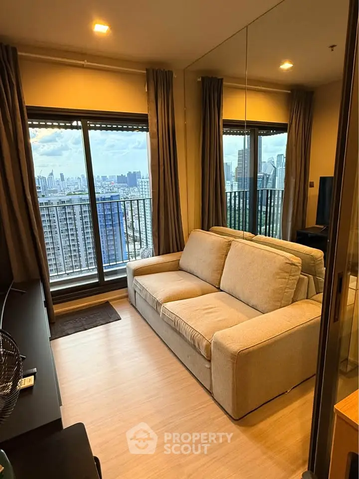 Modern living room with city view and cozy beige sofa in high-rise apartment