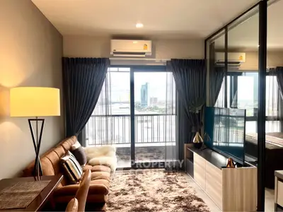 Modern living room with large windows and city view, featuring stylish furniture and decor.