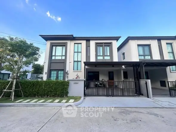 Modern two-story house with sleek design and spacious driveway