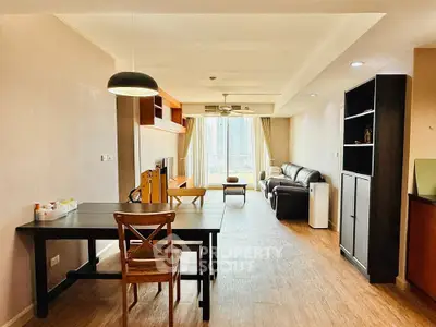Spacious living room with modern decor and large windows offering natural light.