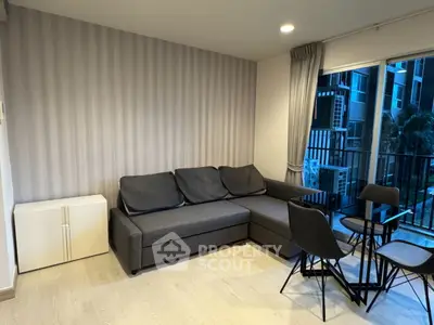 Modern living room with stylish furniture and balcony view in a contemporary apartment.