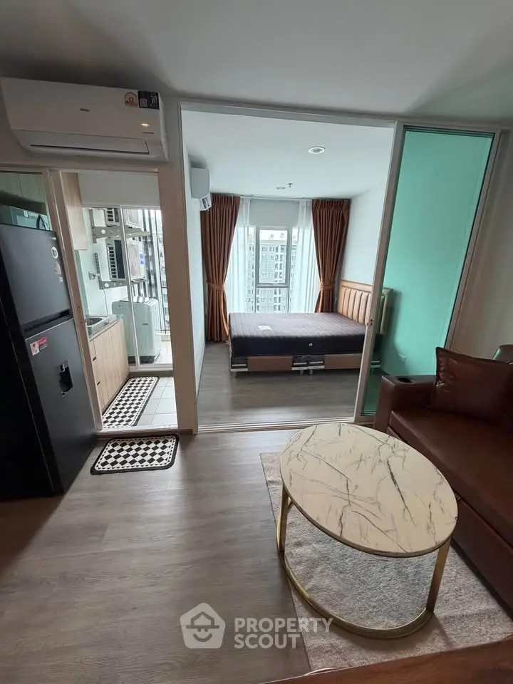 Modern apartment interior with open layout, featuring a cozy living area, stylish kitchen, and inviting bedroom.