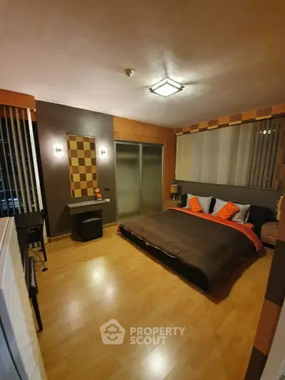 Spacious modern bedroom with stylish decor and ample natural light.