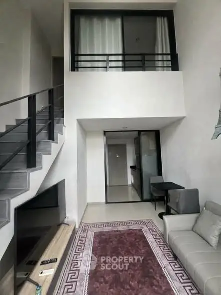 Modern duplex living room with high ceiling and stylish staircase