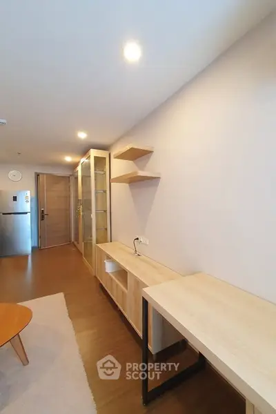 Modern living room with wooden furniture and open layout in a stylish apartment.