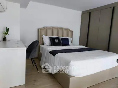 Modern bedroom with elegant decor and spacious wardrobe in a stylish apartment.