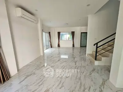 Spacious modern living room with marble flooring and natural light