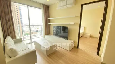 Modern living room with sleek furniture and city view from balcony in high-rise apartment.