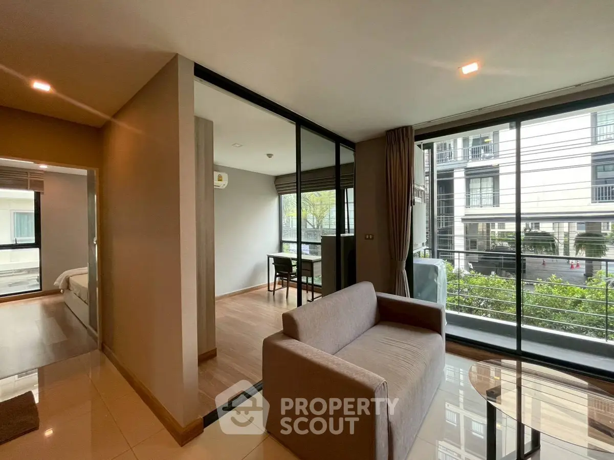 Modern living room with glass partition and city view in stylish apartment