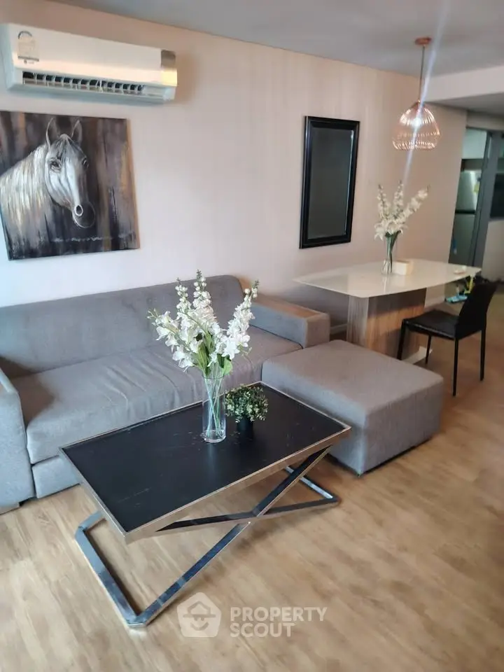 Modern living room with stylish furniture and elegant decor, featuring a cozy sofa and chic dining area.