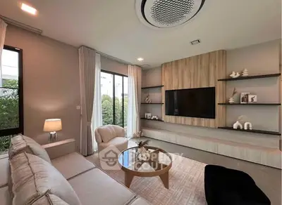 Modern living room with elegant decor and large windows for natural light.