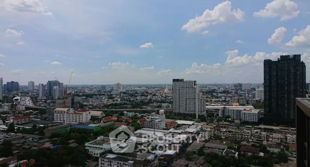 Stunning cityscape view from high-rise building showcasing urban skyline and clear blue sky.