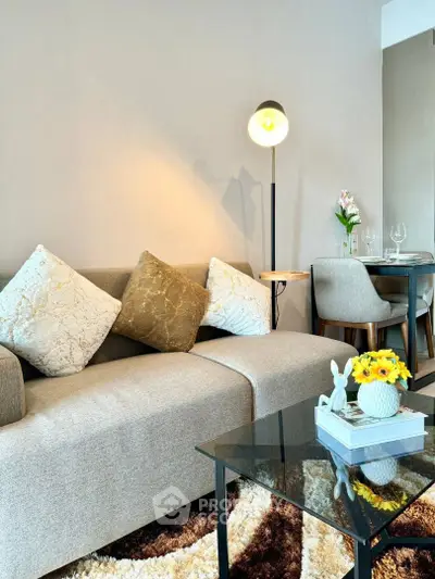 Stylish living room with modern sofa and elegant dining area, perfect for contemporary living.