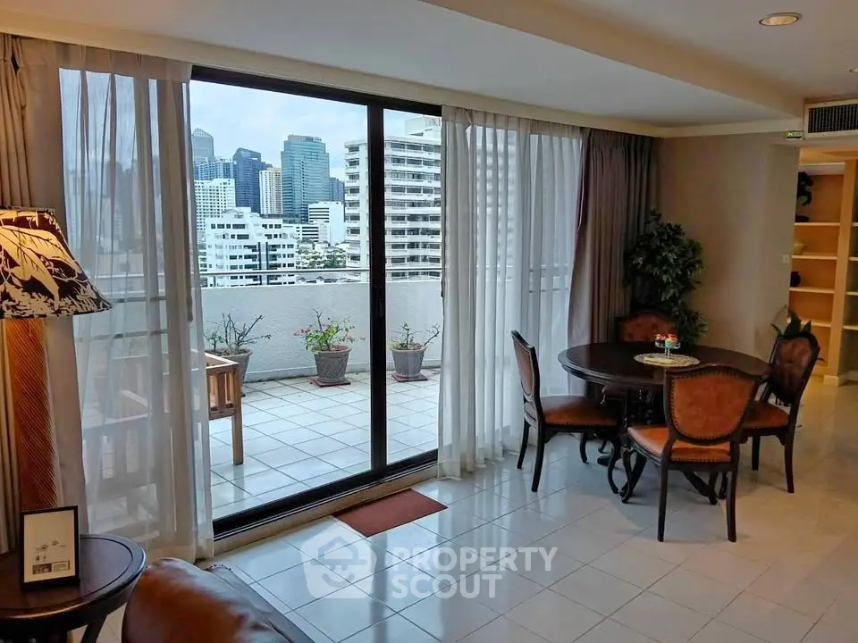 Spacious living room with city view and balcony access in modern apartment.