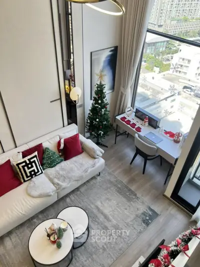 Modern living room with festive decor and city view from large window
