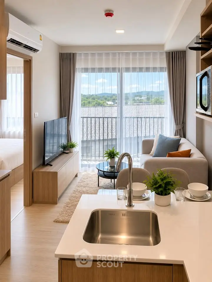 Modern open-plan living room with kitchen, featuring large windows and stylish decor.
