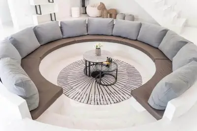 Luxurious circular living room with modern sectional sofa and stylish decor