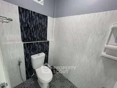 Modern bathroom with stylish tile design and sleek fixtures.