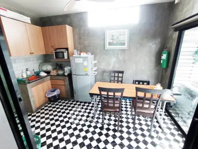 Charming kitchen with modern appliances and stylish checkered flooring, perfect for culinary enthusiasts.