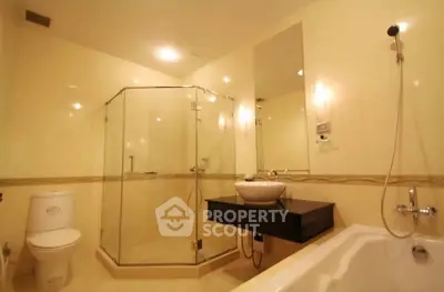 Luxurious bathroom with modern fixtures and spacious shower area in elegant real estate property.