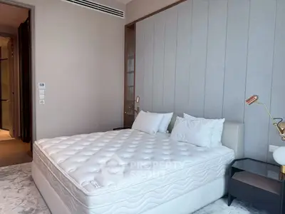 Spacious bedroom with modern decor and comfortable mattress in a stylish apartment.