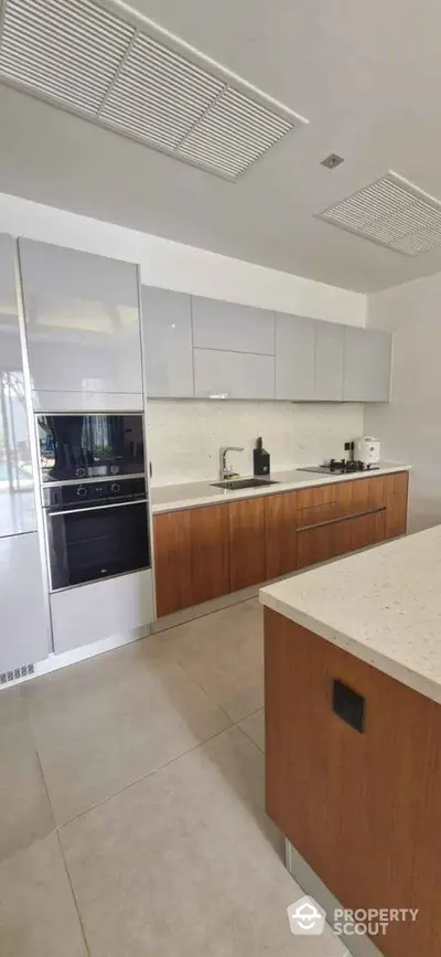 Modern kitchen with sleek cabinetry and built-in oven