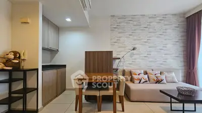 Modern living room with cozy sofa and stylish decor in open layout apartment.