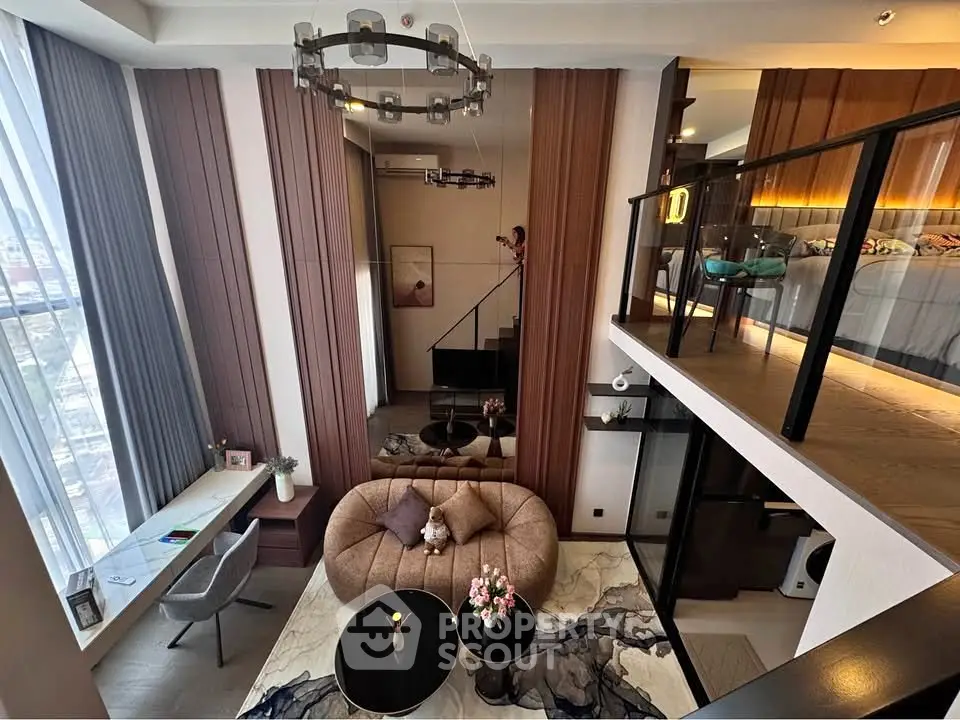 Luxurious modern loft with high ceilings, stylish furniture, and large windows offering stunning city views.