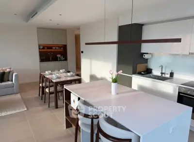 Modern open-plan kitchen and dining area with sleek design and natural light.