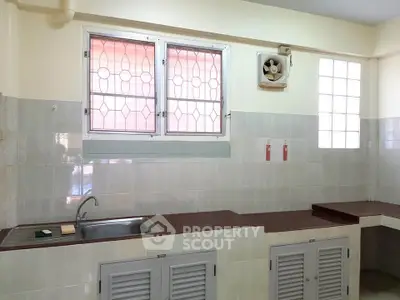 Spacious kitchen with tiled walls and ample counter space