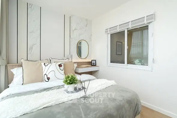 Modern bedroom with stylish decor and natural light