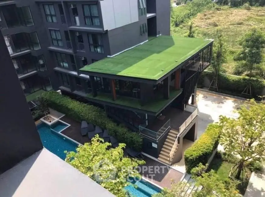 Modern apartment building with rooftop garden and pool view
