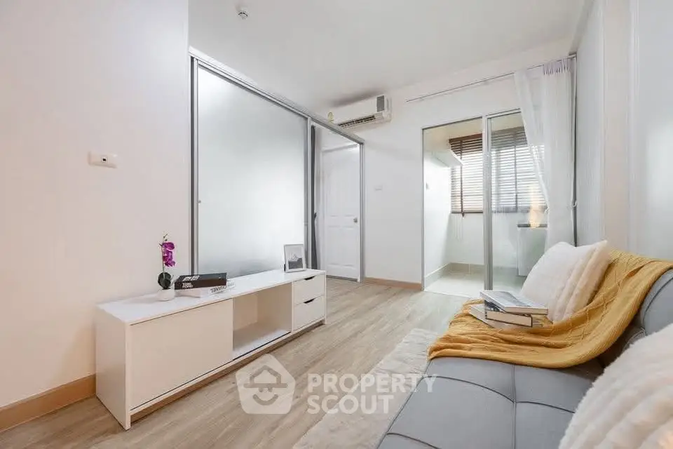 Modern living room with sleek design and natural light, featuring a cozy sofa and stylish decor.