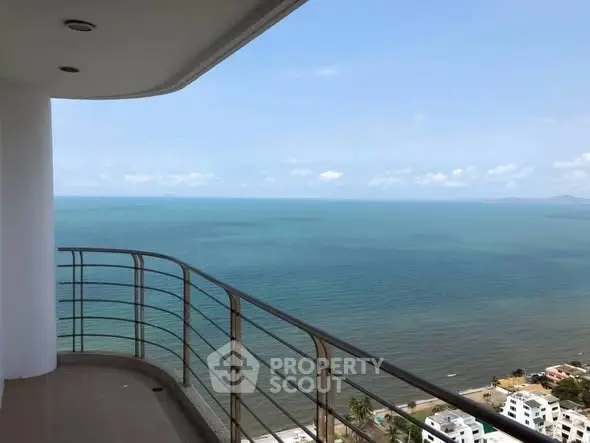 Stunning ocean view from high-rise balcony with clear blue skies.