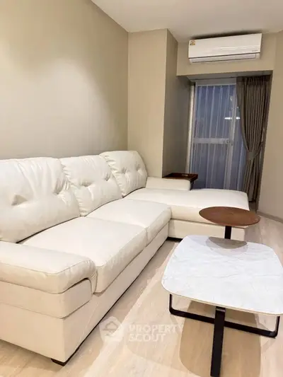 Modern living room with white leather sofa and air conditioning