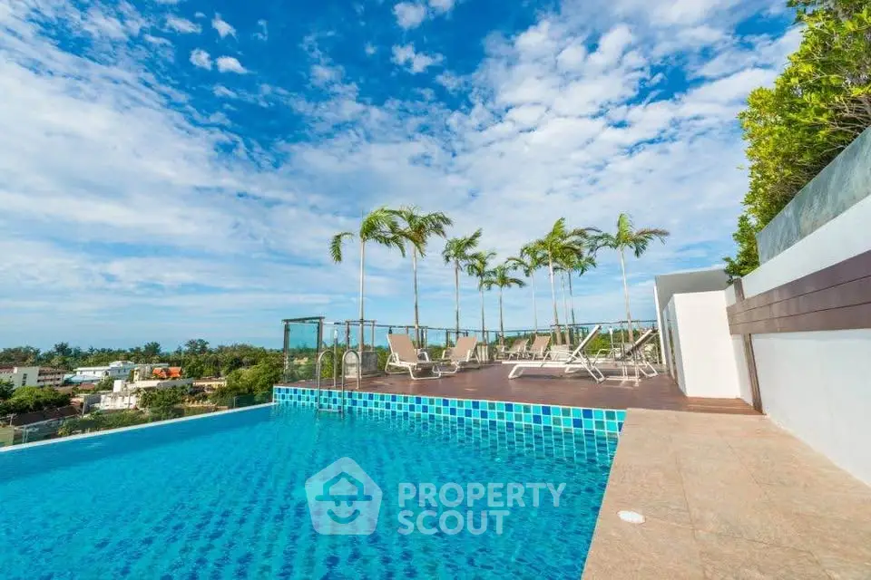 Luxurious rooftop pool with stunning city views and palm trees, perfect for relaxation and leisure.