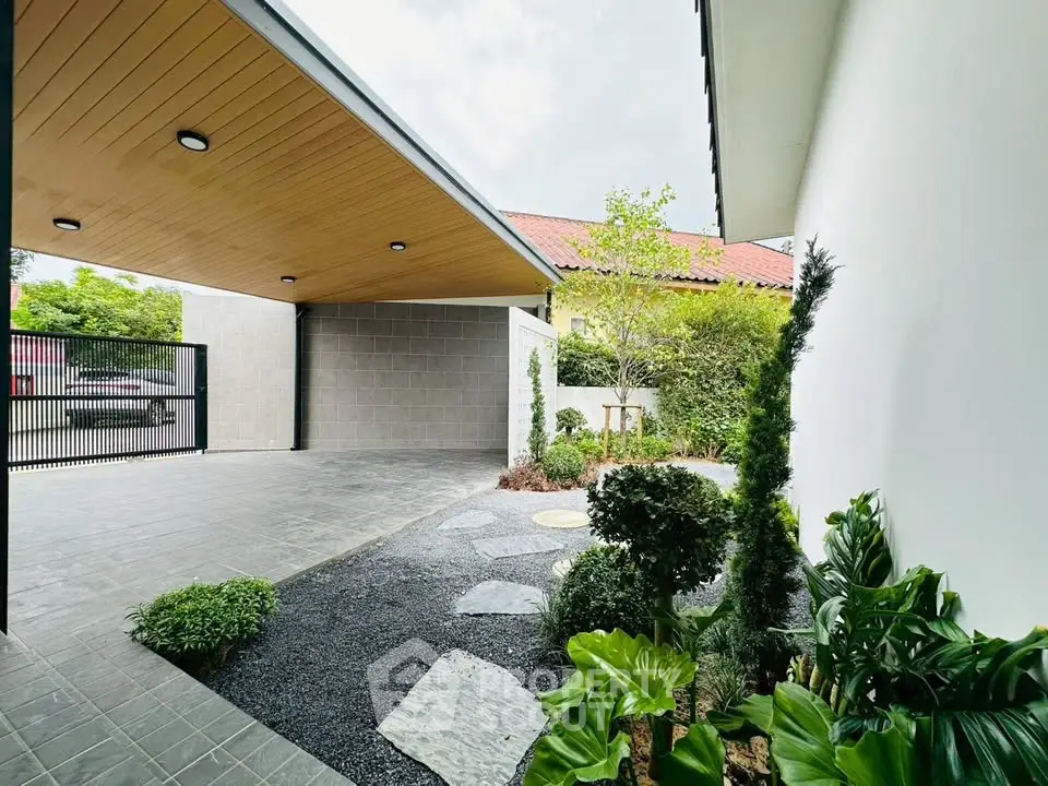 Modern home exterior with sleek carport and landscaped garden