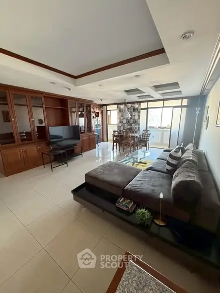 Spacious living room with modern furniture and open dining area