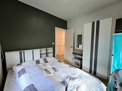 Cozy bedroom with modern furniture and stylish decor in a contemporary home.