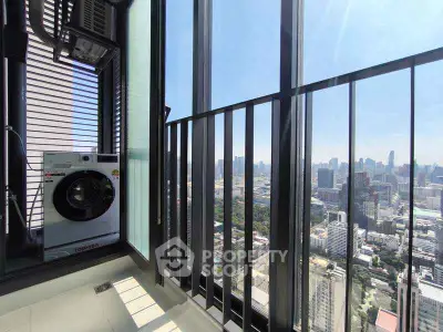 Stunning high-rise balcony with cityscape view and washing machine setup.
