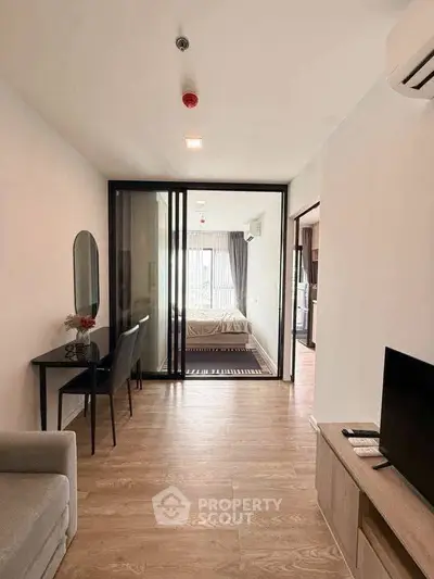 Modern apartment interior with open layout, featuring a cozy living area and stylish bedroom.