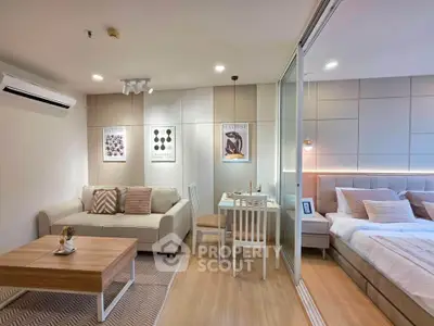 Modern studio apartment with cozy living area and stylish bedroom