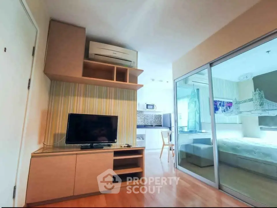 Modern studio apartment with open layout and stylish furnishings, featuring a cozy living area and bedroom separation.