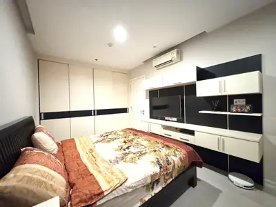 Spacious modern bedroom with stylish built-in storage and air conditioning