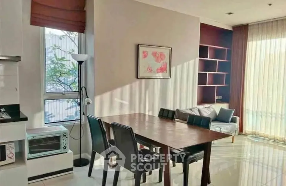 Bright dining area with modern furniture and natural light in a stylish apartment.