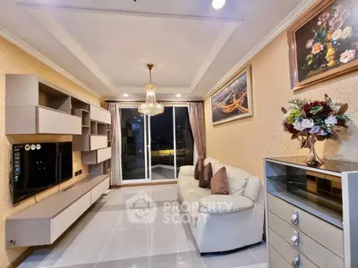 Elegant living room with modern decor, chandelier, and large sliding glass doors leading to a balcony.