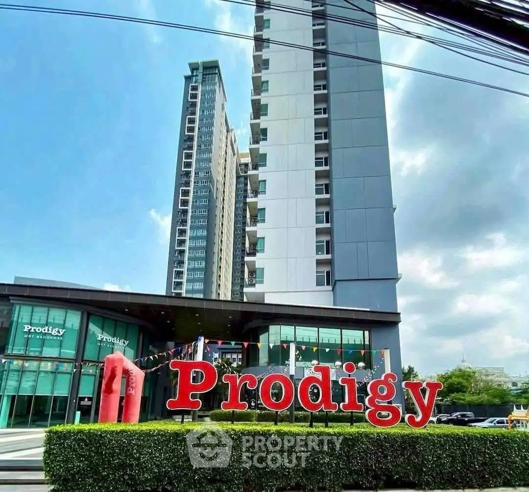 Modern high-rise building with sleek architecture and lush greenery at Prodigy complex.